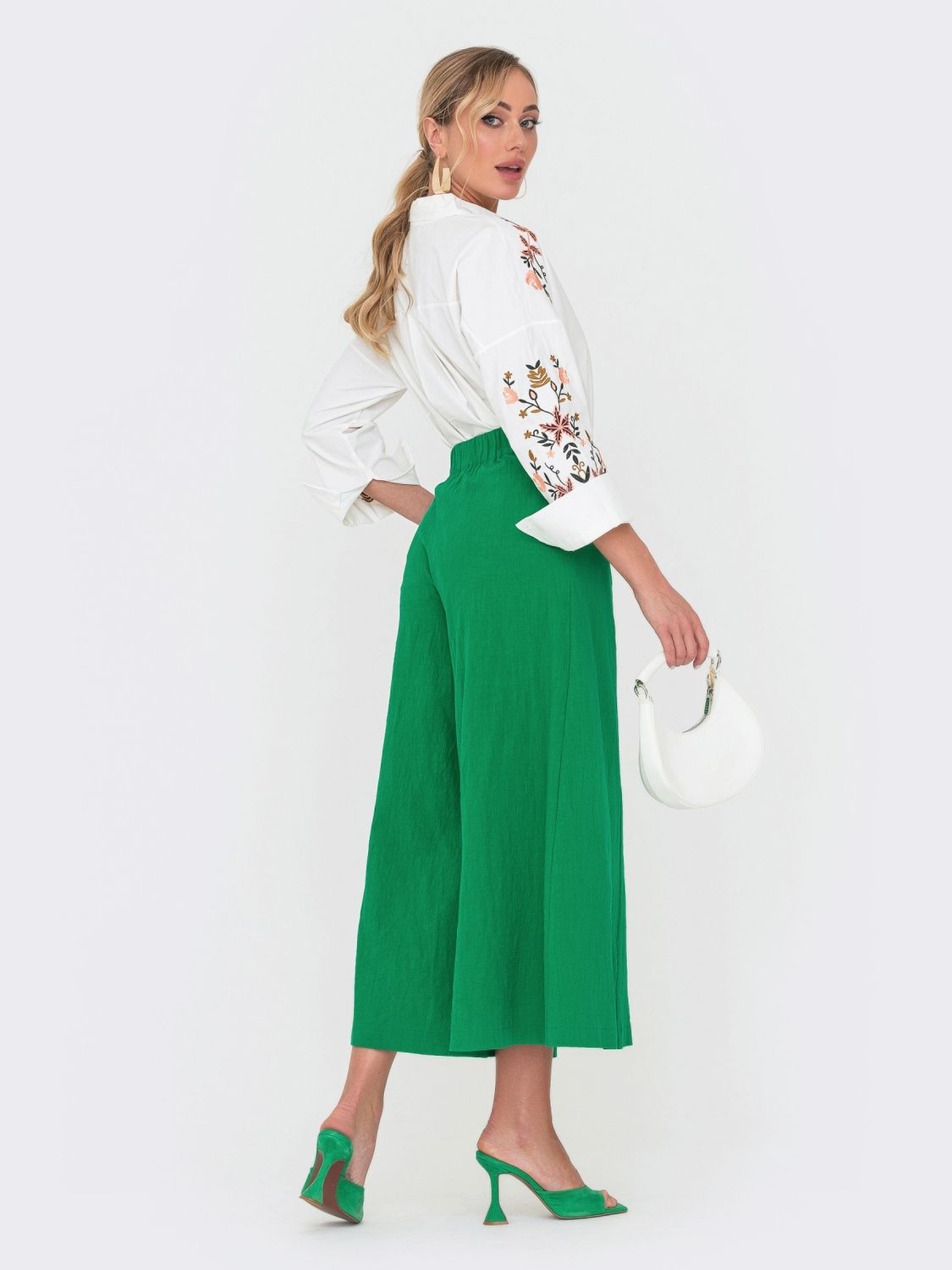 Стильні вкорочені штани-палаццо зеленого кольору - фото